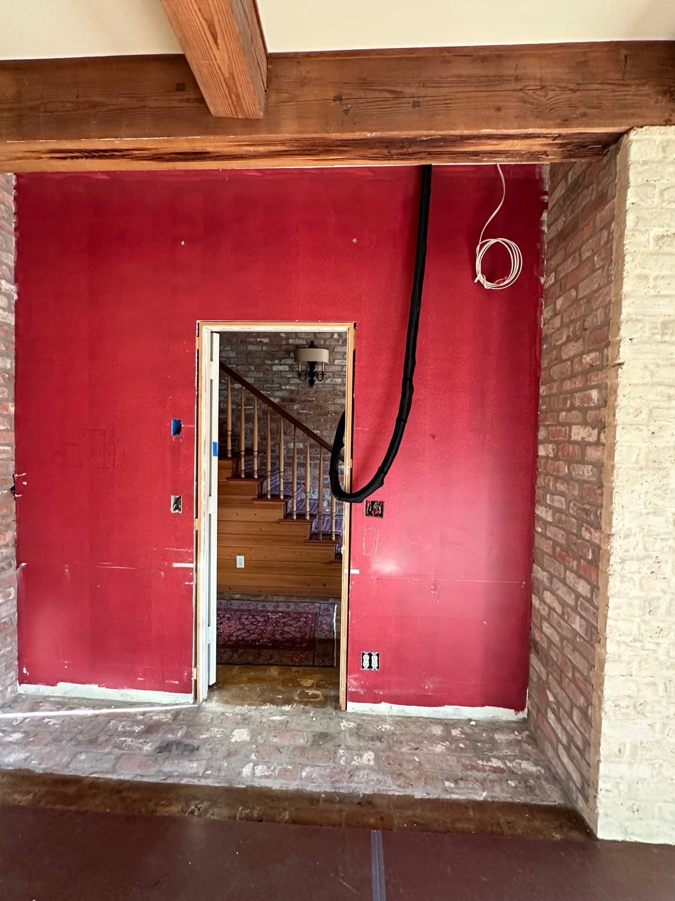 Low-voltage cabling neatly bundled and concealed in conduit run down a wall