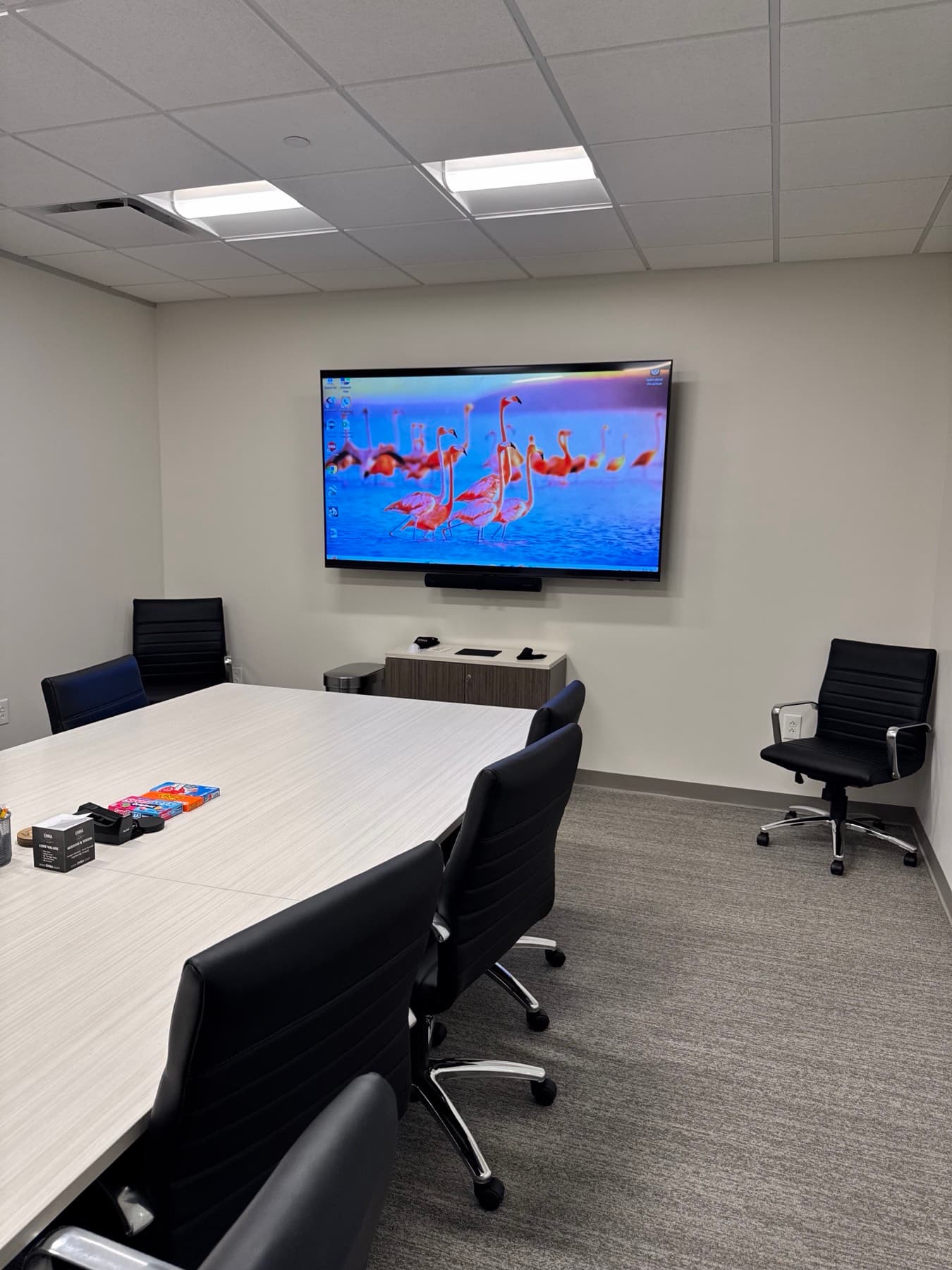 Business conference room with a wall-mounted display and table connectivity