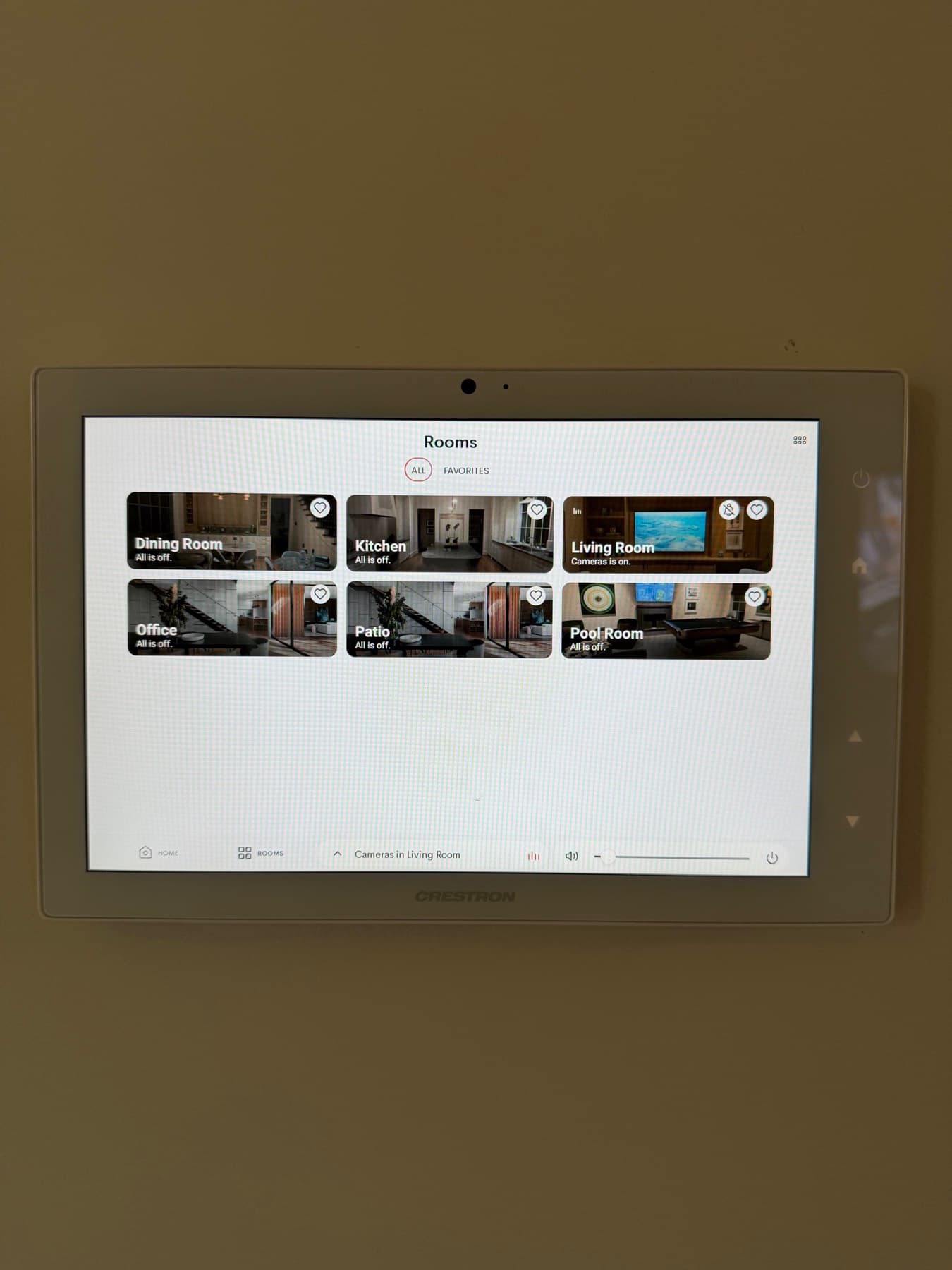 Wall-mounted Crestron Home touch panel showing room-by-room whole-home control in River Oaks