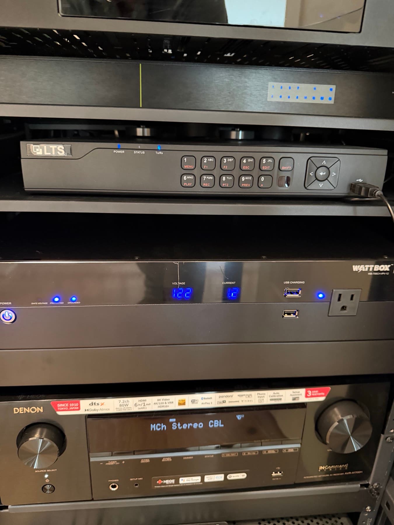 Neatly organized audio-video equipment rack with Denon receiver and WattBox power in Memorial